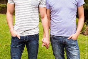 Two men holding hands. Wavebreakmedia/Shutterstock.com